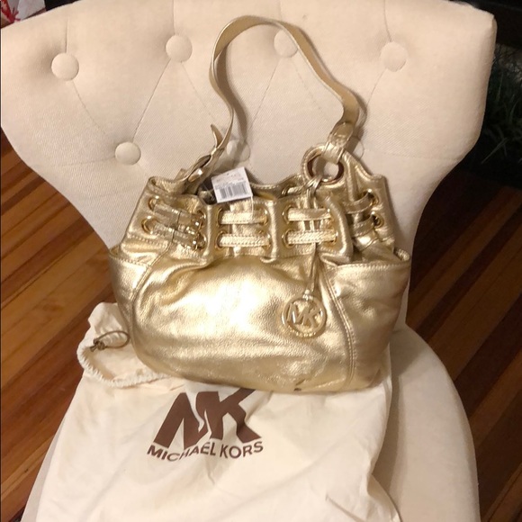 Michael Kors Handbags - NWT MICHAEL KORS LARGE GOLD LACED GROMMET HANDBAG!